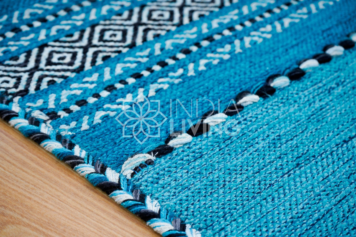 Teal blue kilim rug shown at an alternate angle