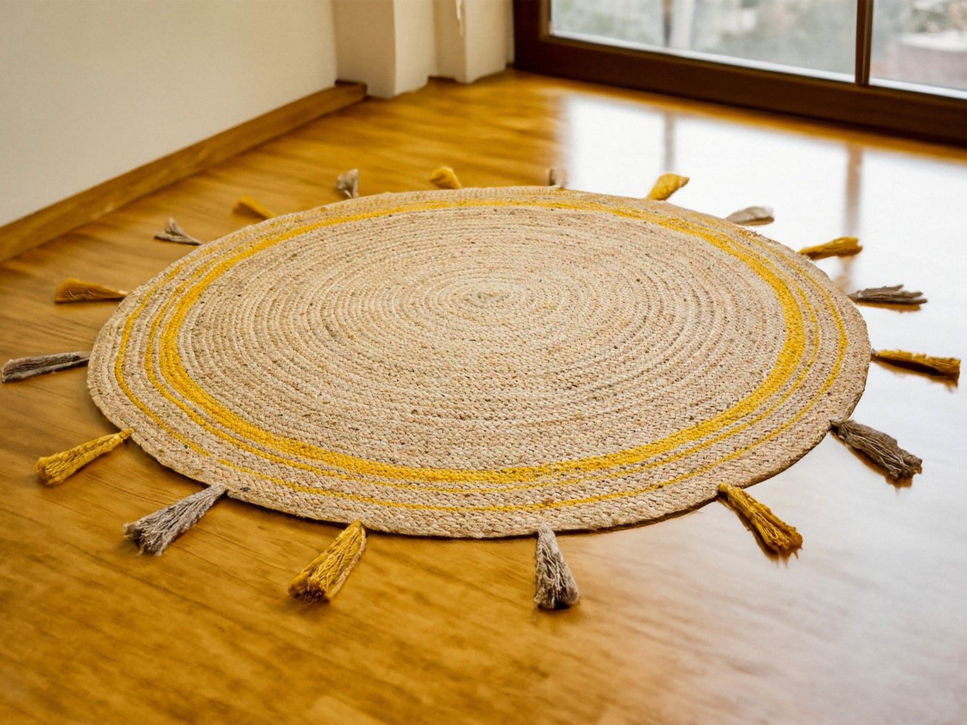 Yellow braided jute mat with tassels, full flat view