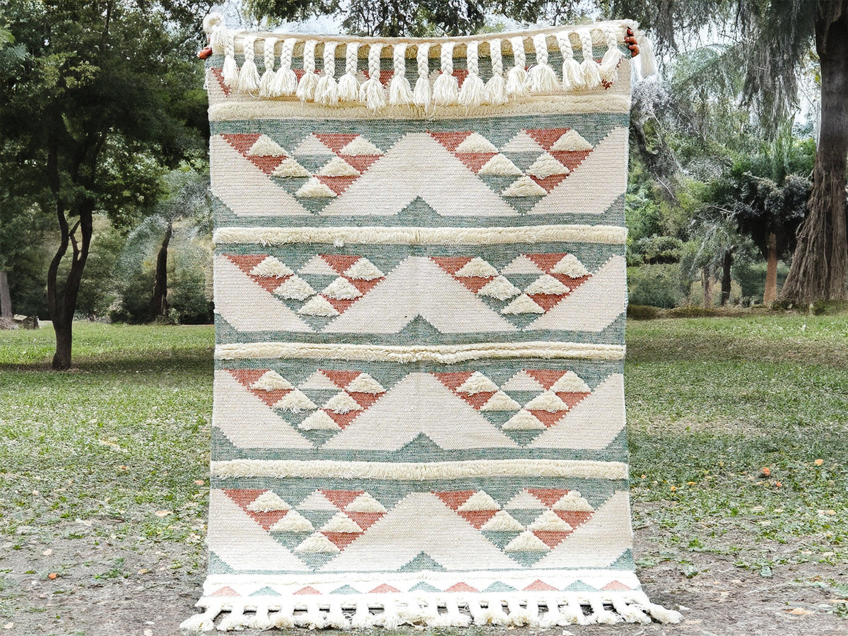 Pink blue kilim rug styled in a pastel living room