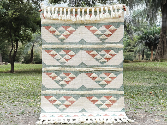 Pink blue kilim rug styled in a pastel living room