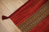 Corner detail of red kilim rug diamond pattern edge