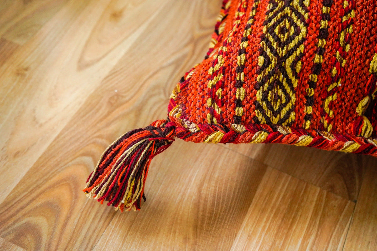 Orange cushions styled on a bohemian sofa