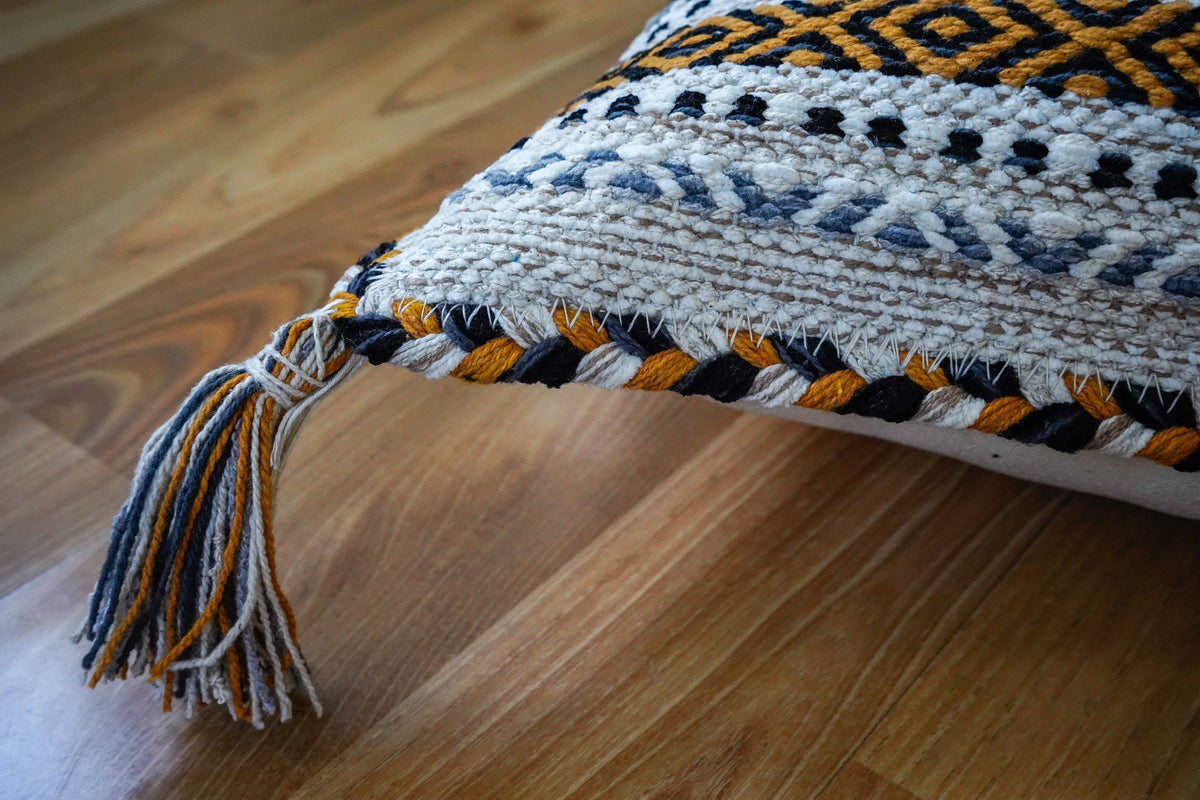 Ivory kilim cushions styled on a sofa