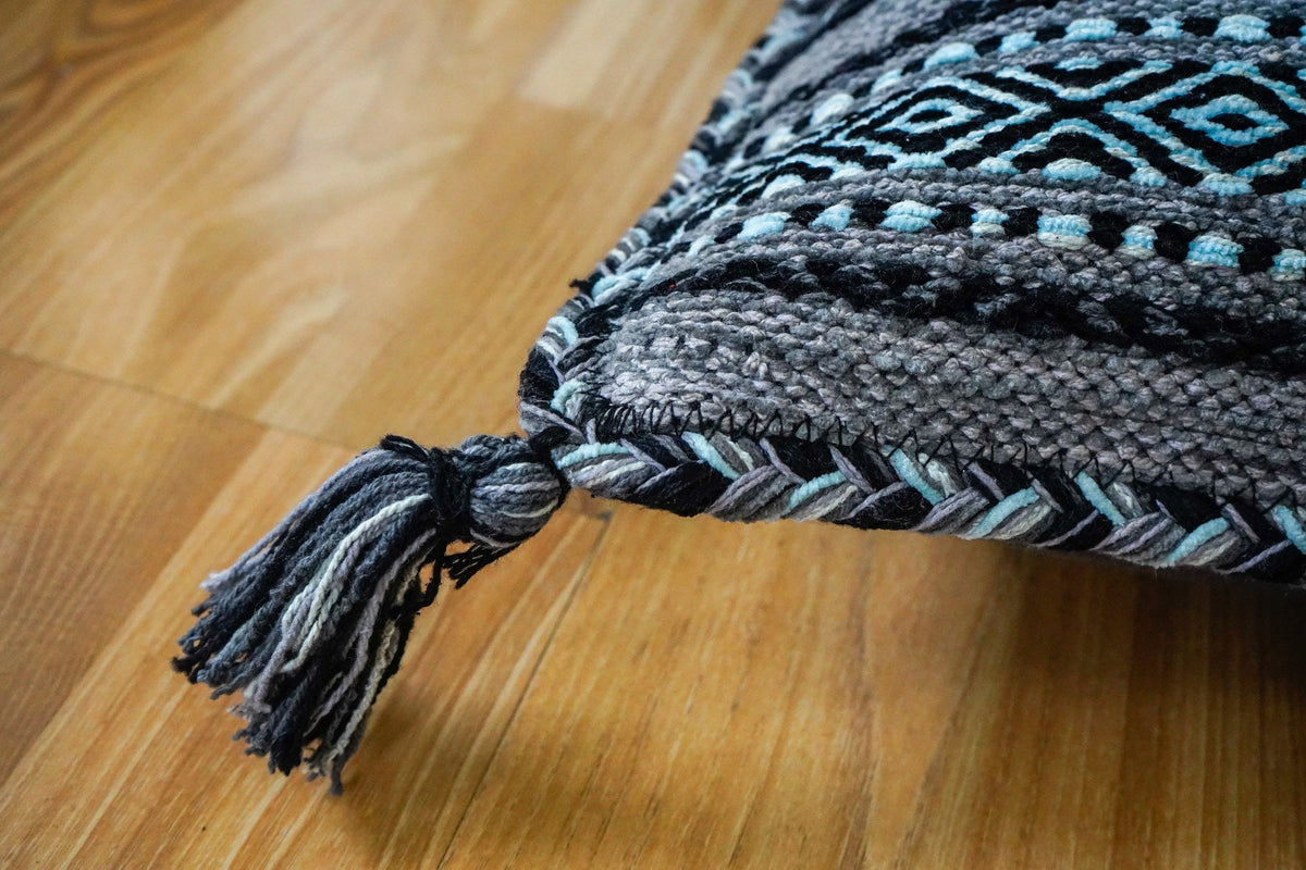 Grey kilim cushions styled on a sofa