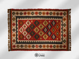 Red kilim rug placed on a patio setting