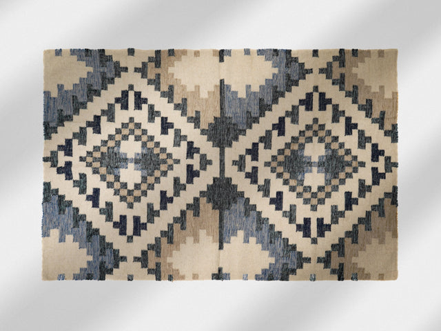 Beige blue kilim rug styled in a Scandinavian living room
