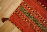 Red kilim rug styled in a bedroom