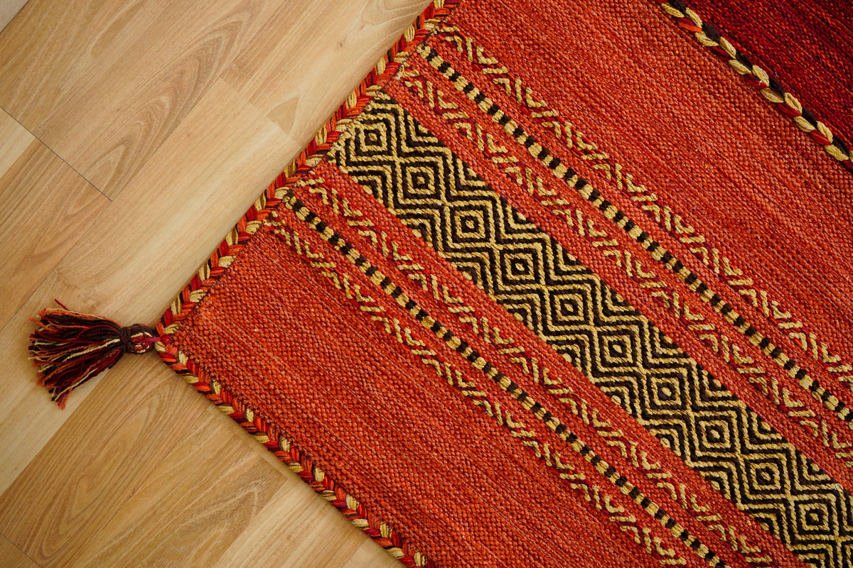 Red kilim rug styled in a bedroom