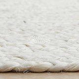 White jute rug styled in living room