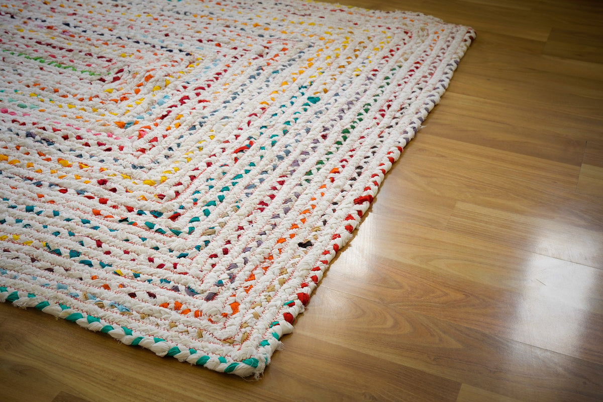Rainbow rag rug placed in a bedroom setting