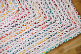 Rainbow chindi rag rug styled with colorful home decor