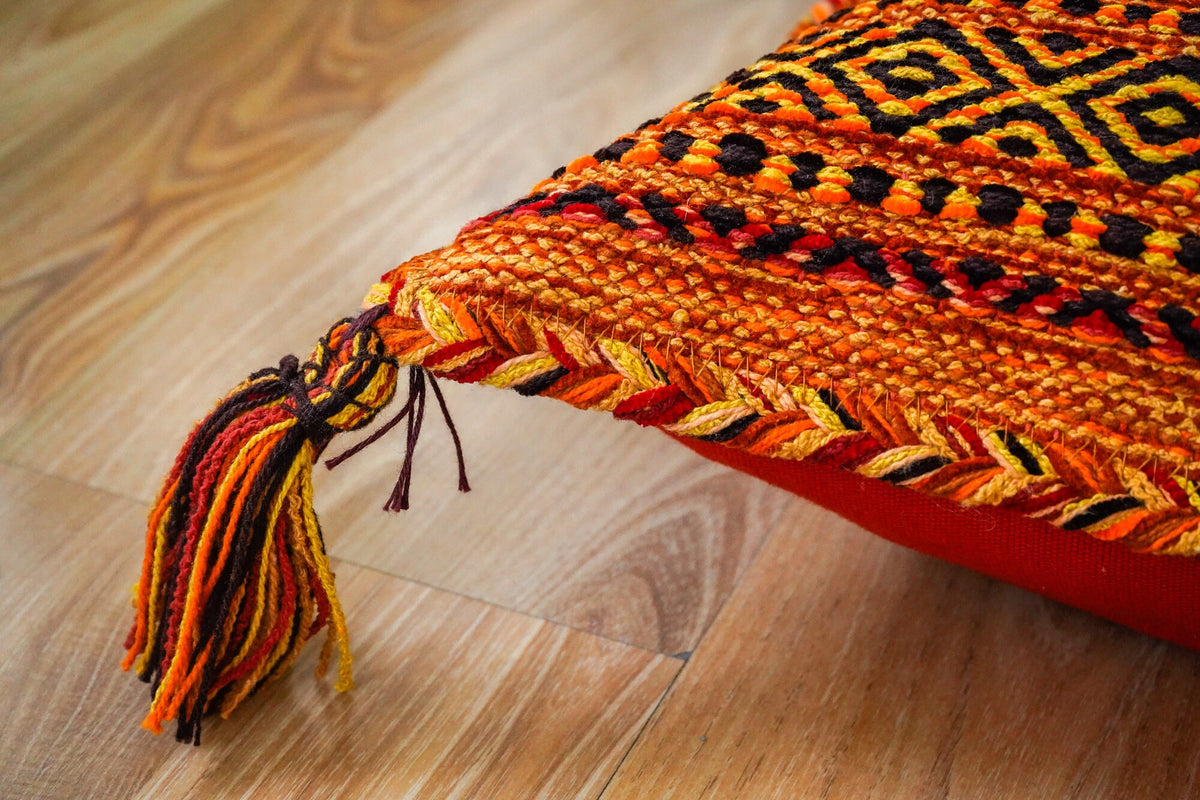 Full view of orange Moroccan cushion set