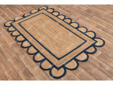 Full view of navy blue scalloped rug in natural light