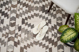 Grey chenille rug placed in bedroom setting