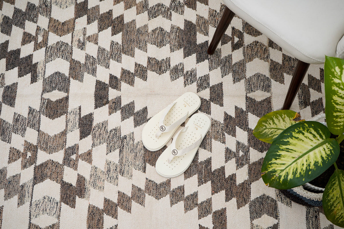 Grey chenille rug placed in bedroom setting