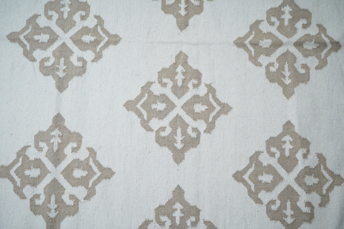 White wool kilim rug laid in a classic interior