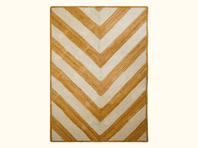 White jute braided rug styled in a bright living room