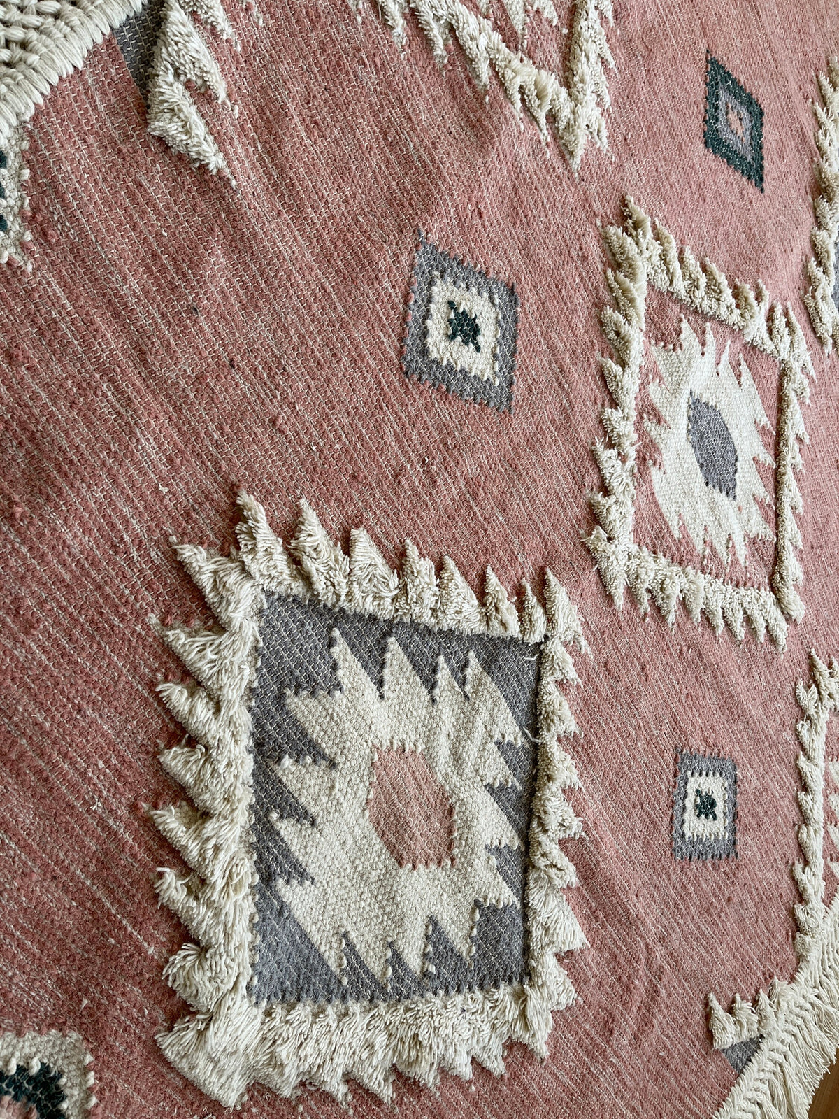 Pink rug placed under dining room table