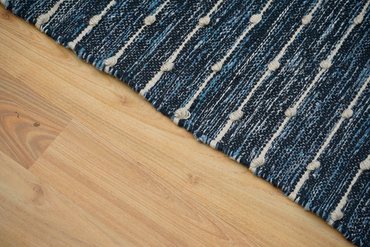 Close-up of dense fringe and knotted tassels on kilim rug