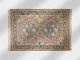 Pink kilim rug styled in a bedroom setting