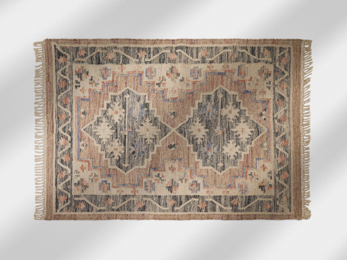 Pink kilim rug styled in a bedroom setting