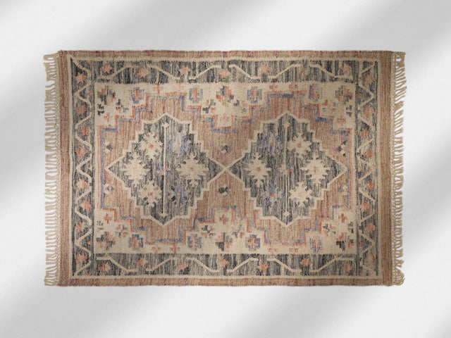 Pink kilim rug styled in a bedroom setting