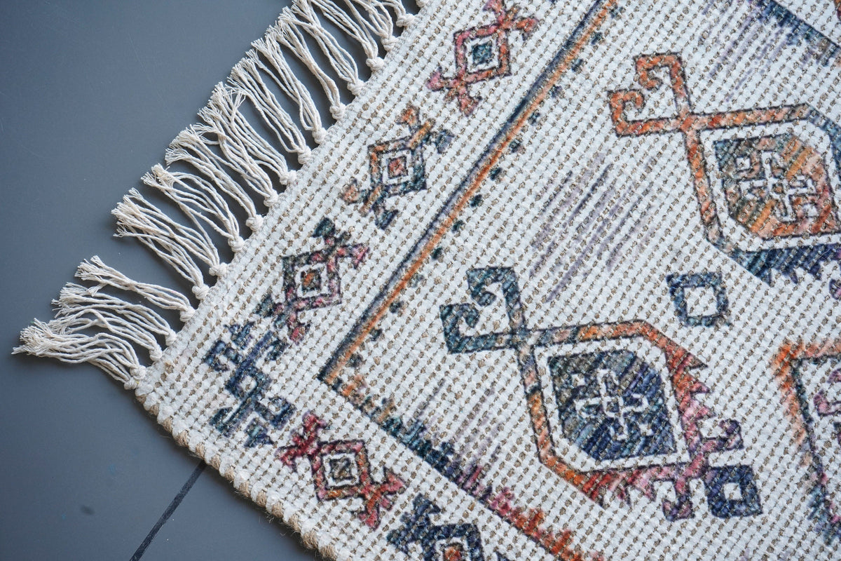 Ivory jute rug styled in a bedroom setting