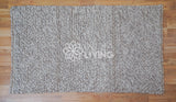 Beige wool rug in cozy styled room