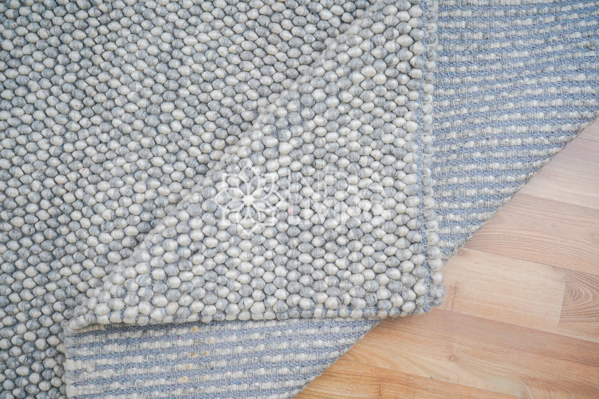 Grey wool rug in cozy styled room