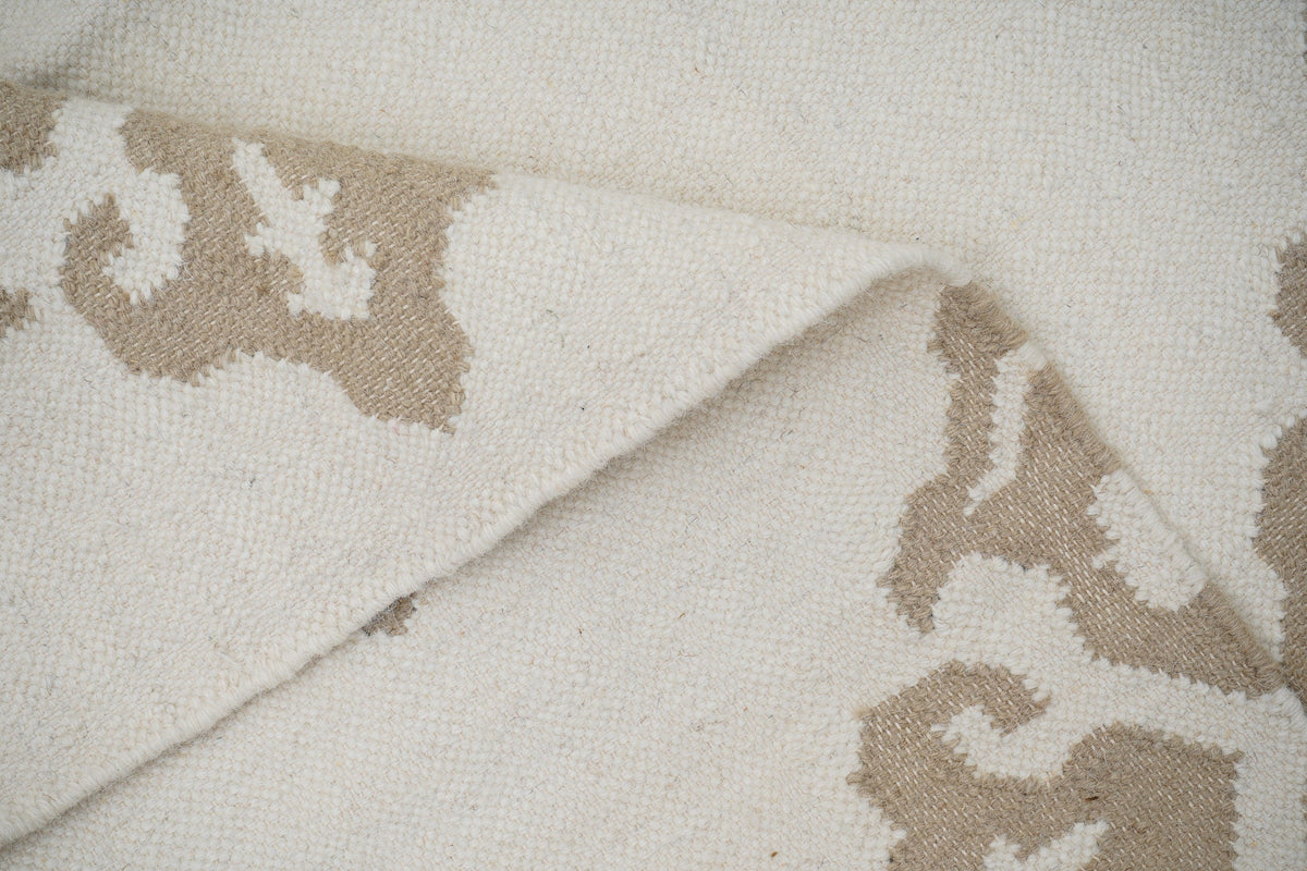 White wool kilim rug in a bedroom setting