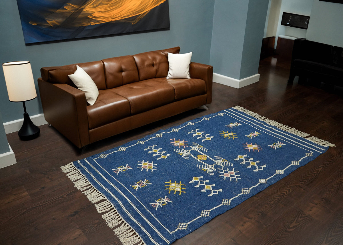 Blue Aztec kilim rug styled in a living room