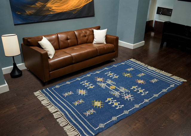 Blue Aztec kilim rug styled in a living room