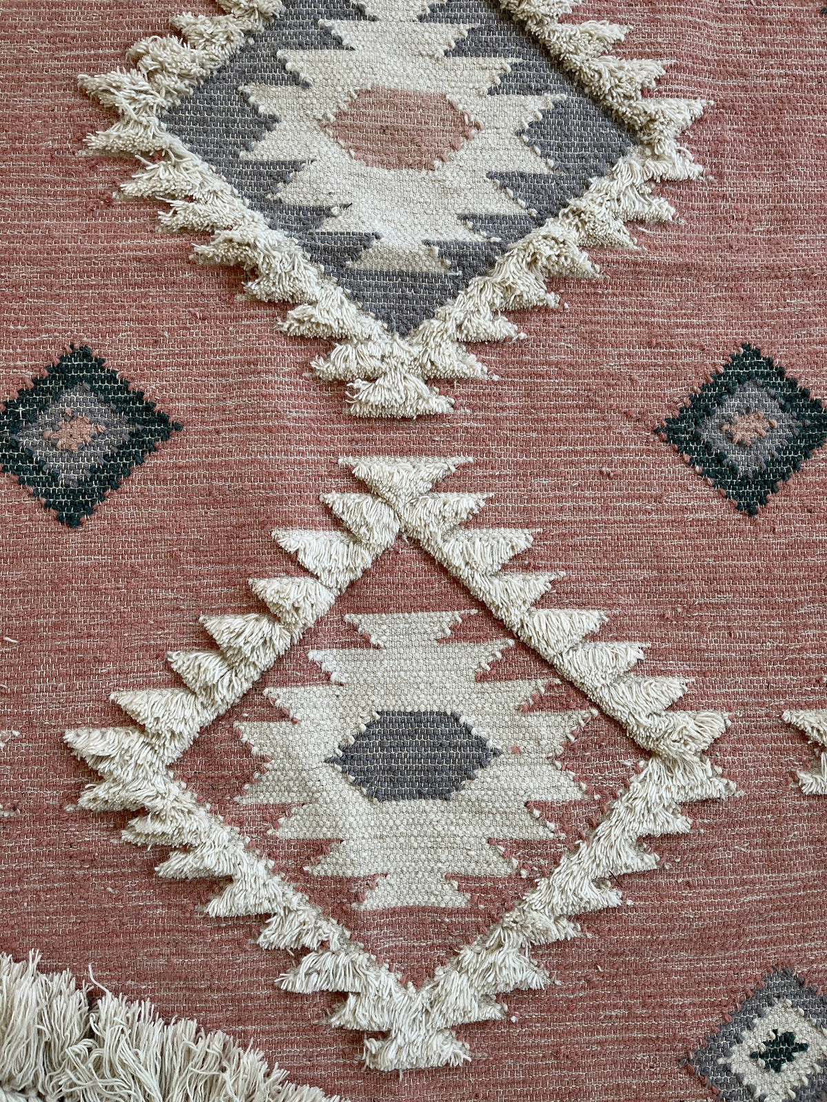 Oval rug shown in nursery setting with natural light