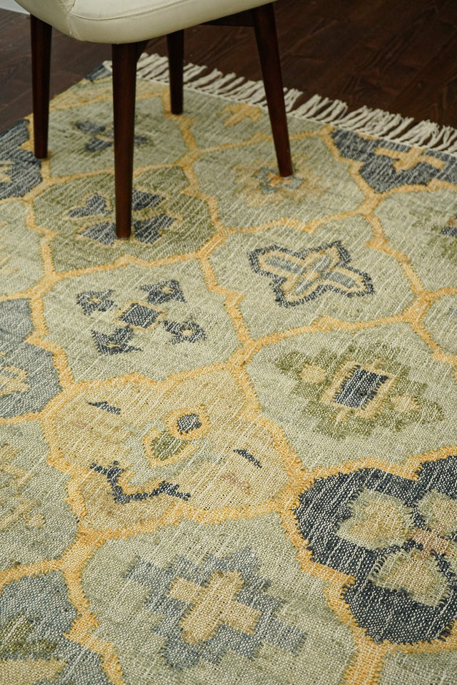Sage green flatweave jute rug flat view showing abstract pattern