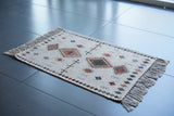 Corner detail of ivory Moroccan print rug edge