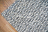 Grey wool rug texture close-up detail