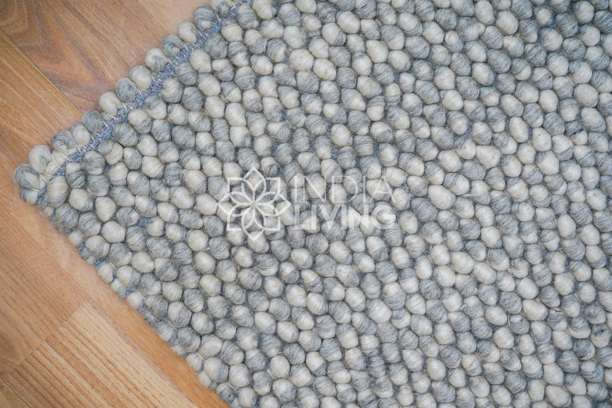 Grey wool rug texture close-up detail