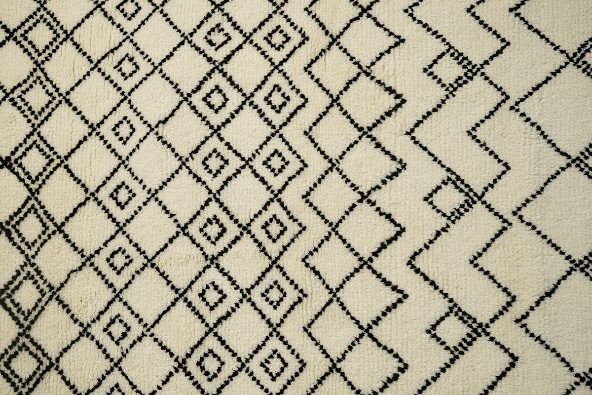 Full view of ivory Berber wool rug on floor