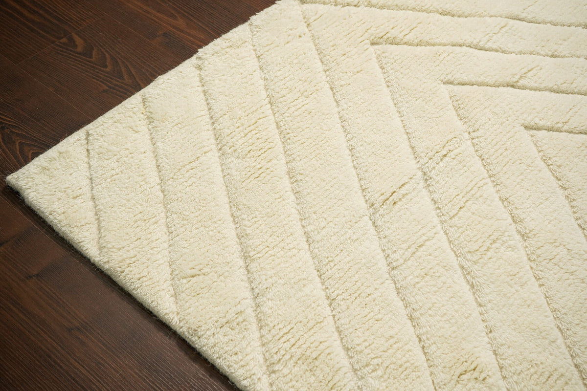 Ivory rug edge and fringe close-up detail