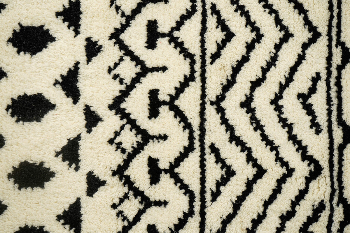 Ivory hand-knotted rug in a bedroom setting