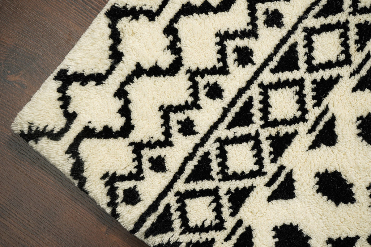Ivory wool rug placed under a coffee table setting