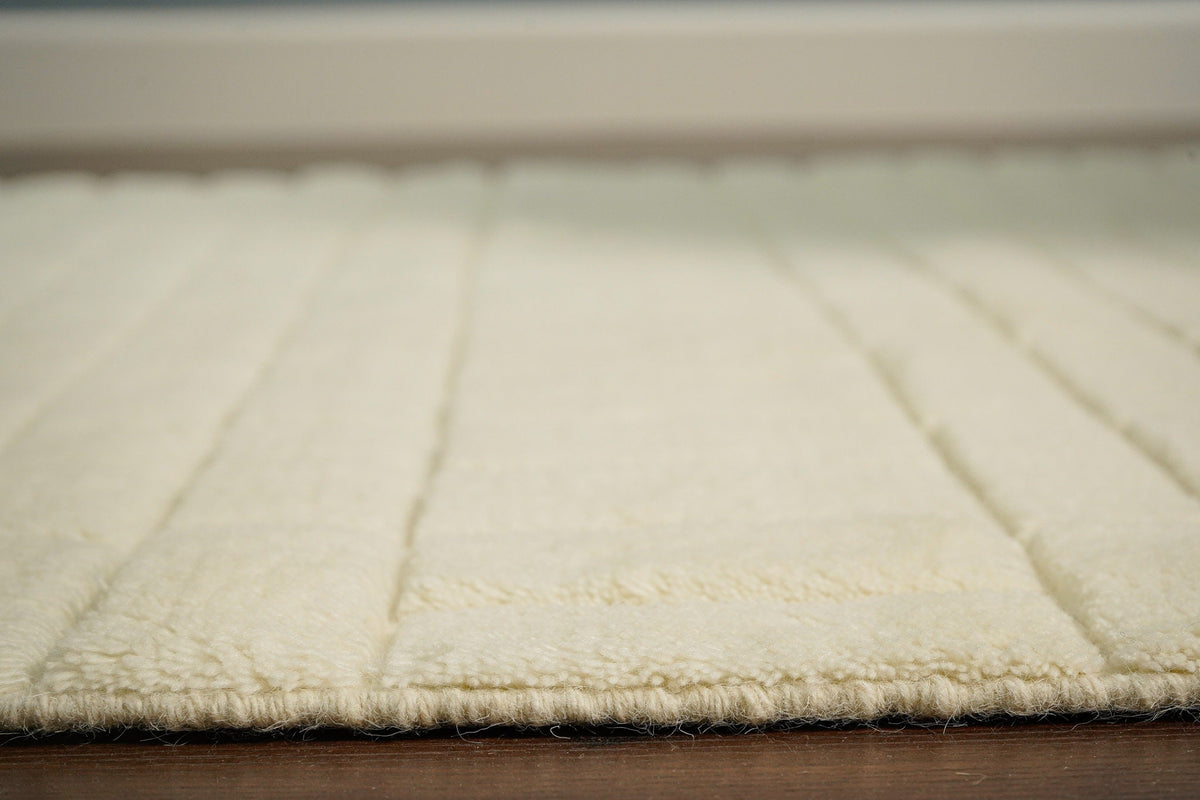 Ivory wool rug texture close-up showing pile
