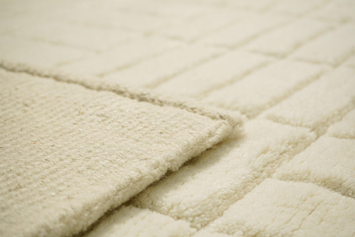 Ivory rug corner detail with fringe edge