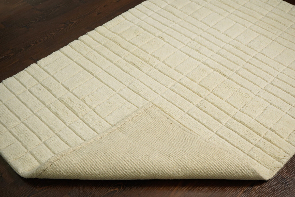 Ivory rug edge and fringe close-up detail
