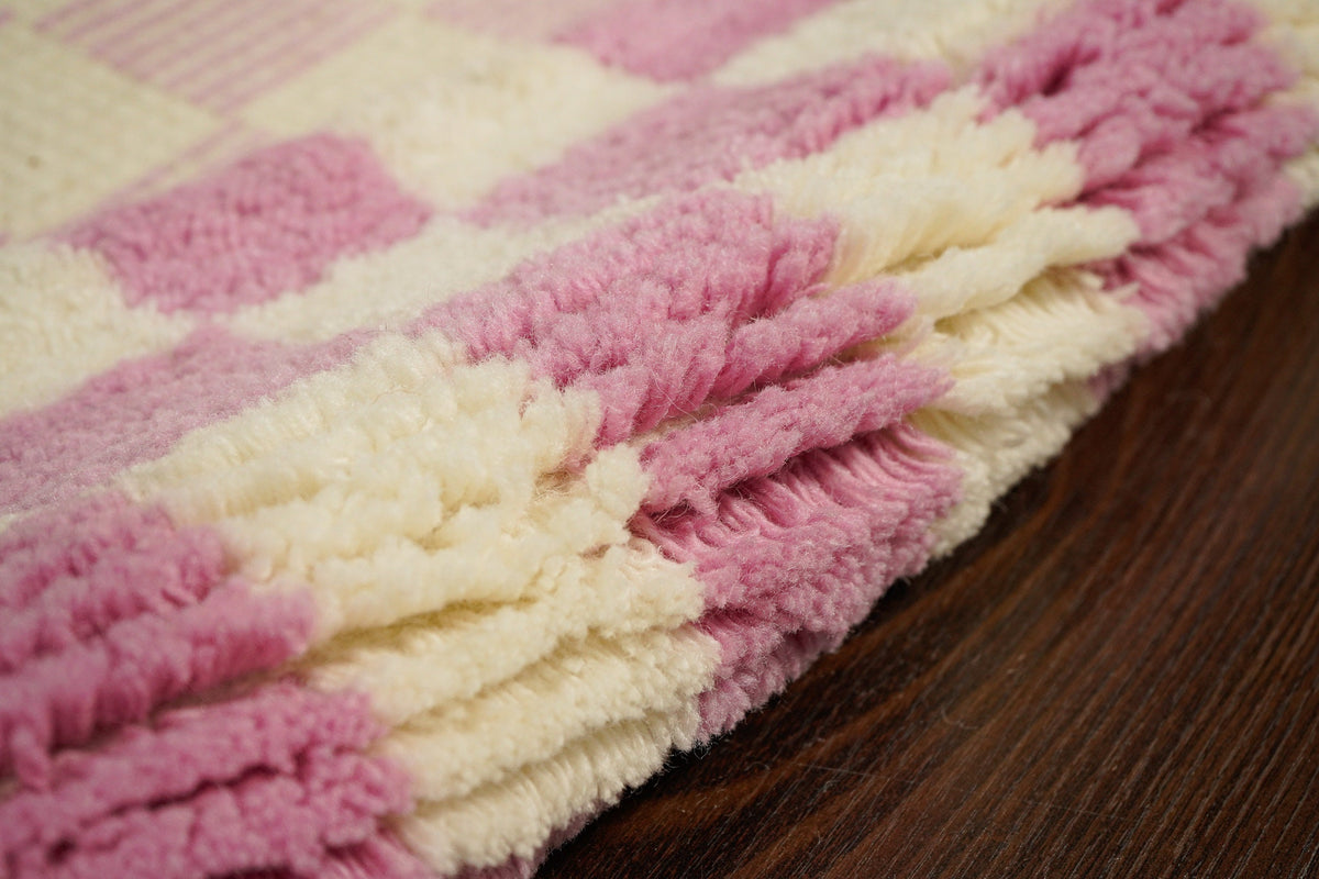 Pink checkered wool rug flat lay