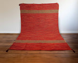 Close-up of cotton chenille texture on red kilim rug
