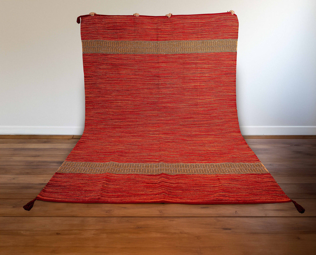 Close-up of cotton chenille texture on red kilim rug
