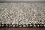 Handwoven charcoal wool rug edge and border detail