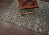 Charcoal brown wool rug full room lifestyle shot