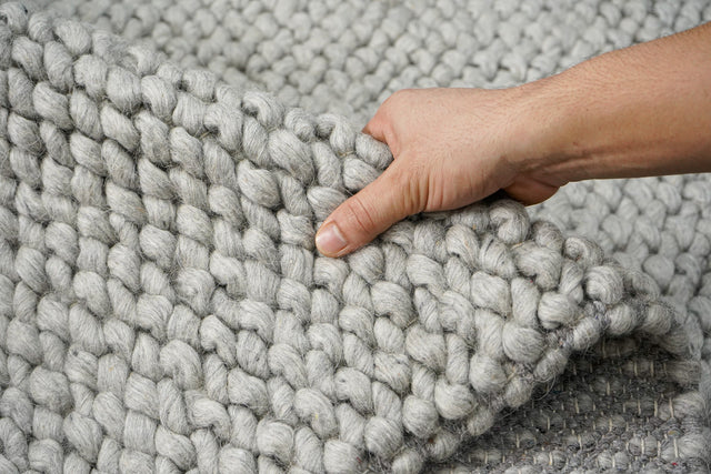 Grey chunky looped wool rug, flat lay view